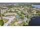 Aerial view of the community with a pool, tennis courts, and lake access at 90 S Highland Ave # 6, Tarpon Springs, FL 34689