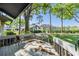 Outdoor back deck showcasing views of the landscaped backyard with mature trees and community tennis courts at 90 S Highland Ave # 6, Tarpon Springs, FL 34689