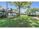Spacious backyard featuring lush green grass and mature trees, ideal for outdoor activities and relaxation at 90 S Highland Ave # 6, Tarpon Springs, FL 34689