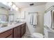 Bathroom with granite countertops, wood cabinets and decorative glass shelving at 90 S Highland Ave # 6, Tarpon Springs, FL 34689