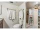 Bathroom featuring a walk-in shower and decorative glass shelving for storage at 90 S Highland Ave # 6, Tarpon Springs, FL 34689