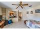 Bedroom with tiled floor, ceiling fan and pass-through to kitchen at 90 S Highland Ave # 6, Tarpon Springs, FL 34689