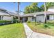 Inviting single-story home featuring a well-manicured lawn and walkway at 90 S Highland Ave # 6, Tarpon Springs, FL 34689