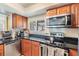 Well-equipped kitchen with black countertops and stainless steel appliances at 90 S Highland Ave # 6, Tarpon Springs, FL 34689