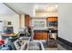 Bright kitchen featuring a stainless steel sink, wood cabinets, granite countertops and a breakfast bar at 90 S Highland Ave # 6, Tarpon Springs, FL 34689