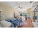 Bright main bedroom with wood floors, ceiling fan, and large windows offering natural light at 90 S Highland Ave # 6, Tarpon Springs, FL 34689