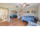 Comfortable main bedroom featuring a ceiling fan, mirrored closet doors, and ensuite bathroom at 90 S Highland Ave # 6, Tarpon Springs, FL 34689