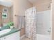 Bathroom featuring a shower and tub combination with white tile surround at 2709 Via Cipriani # 522B, Clearwater, FL 33764