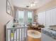 Cozy Bedroom with crib, chair, and ample storage at 2709 Via Cipriani # 522B, Clearwater, FL 33764