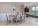 Dining area with fireplace, TV, and large windows at 2709 Via Cipriani # 522B, Clearwater, FL 33764