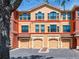Townhouse exterior showing the red outline of its boundaries and three garage doors at 2709 Via Cipriani # 522B, Clearwater, FL 33764