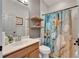 Bathroom with a vanity, shelves, and a shower with a decorative starfish curtain at 10229 Avelar Ridge Dr, Riverview, FL 33578