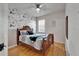 Bedroom with decorative floral wallpaper and natural wood flooring at 10229 Avelar Ridge Dr, Riverview, FL 33578