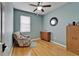Bedroom with hardwood floors, a wooden cabinet and a teal painted walls at 10229 Avelar Ridge Dr, Riverview, FL 33578