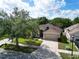 Well-maintained home with a two-car garage, landscaping, and a spacious front yard under a sunny sky at 10229 Avelar Ridge Dr, Riverview, FL 33578