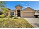 Charming single-story home featuring a well-manicured lawn, two car garage, and inviting curb appeal at 10229 Avelar Ridge Dr, Riverview, FL 33578