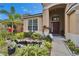 Inviting entrance of this home is framed by lush landscaping and a quaint pond at 10229 Avelar Ridge Dr, Riverview, FL 33578