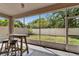 Screened patio featuring outdoor seating and view of fenced yard at 10229 Avelar Ridge Dr, Riverview, FL 33578