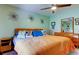 Bright bedroom with a queen bed, hardwood floors, and stylish decor at 10601 42Nd N Ct, Clearwater, FL 33762