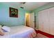 Bedroom with a large closet, a white bed, and red wood-look flooring at 10601 42Nd N Ct, Clearwater, FL 33762