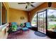 Cozy front porch with tiled floor, seating, and decorative iron gate at 10601 42Nd N Ct, Clearwater, FL 33762