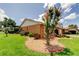 Landscaped front yard with stone mulch, brick borders, and ornamental trees at 10601 42Nd N Ct, Clearwater, FL 33762