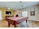 Recreation game room with a pool table, TV, and seating offers plenty of space for entertainment and social activities at 10601 42Nd N Ct, Clearwater, FL 33762