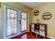 Hallway with french doors to the backyard and a rolling storage console at 10601 42Nd N Ct, Clearwater, FL 33762