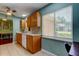 Bright kitchen with wooden cabinets, white countertops and appliances, and tiled floors at 10601 42Nd N Ct, Clearwater, FL 33762