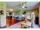 Open concept living room, with tan recliner chair, dining area, and dark wood floors at 10601 42Nd N Ct, Clearwater, FL 33762