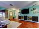 Open-concept living area with modern TV console and hardwood floors at 10601 42Nd N Ct, Clearwater, FL 33762