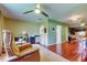 Living room view, with tan recliner chair, ceiling fan, and dark wood floors at 10601 42Nd N Ct, Clearwater, FL 33762