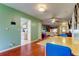 Open concept living area connecting to kitchen and features wood floors and bright decor at 10601 42Nd N Ct, Clearwater, FL 33762
