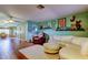 Bright living room with hardwood floors, white sofa, and open layout at 10601 42Nd N Ct, Clearwater, FL 33762
