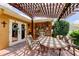 Inviting brick patio with a pergola and an outdoor dining set, perfect for relaxing or entertaining at 10601 42Nd N Ct, Clearwater, FL 33762