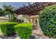 Charming covered patio with a pergola surrounded by lush greenery and flowering trees, ideal for outdoor enjoyment at 10601 42Nd N Ct, Clearwater, FL 33762