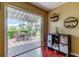 Patio view with sliding glass doors and a table and chairs under a pergola at 10601 42Nd N Ct, Clearwater, FL 33762