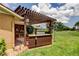 Outdoor cooking area with a built-in grill and a charming pergola-covered patio, perfect for summer barbecues at 10601 42Nd N Ct, Clearwater, FL 33762