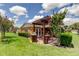 Relaxing outdoor patio with a pergola, built-in grill, and comfortable seating, perfect for outdoor entertaining at 10601 42Nd N Ct, Clearwater, FL 33762