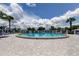 Beautiful outdoor community pool is surrounded by palm trees and lounge chairs, perfect for relaxing and enjoying the sunshine at 10601 42Nd N Ct, Clearwater, FL 33762