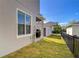 Backyard view featuring a patio with grill and an attached garage with a grey door at 11309 Grand Park Ave, Riverview, FL 33578