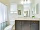 Well-lit bathroom featuring modern fixtures, a large mirror, and tile flooring at 11309 Grand Park Ave, Riverview, FL 33578