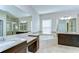 Luxurious bathroom with dual vanities, soaking tub, and tiled shower at 11309 Grand Park Ave, Riverview, FL 33578