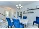 Open-concept dining room features a modern chandelier, stylish decor, and seamless access to other areas of the home at 11309 Grand Park Ave, Riverview, FL 33578