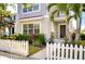 Inviting home entrance with a picket fence, lush landscaping, and a walkway leading to the front door with a Ring doorbell at 11309 Grand Park Ave, Riverview, FL 33578