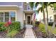 Charming home entrance with an American flag, well-maintained landscaping, and walkway at 11309 Grand Park Ave, Riverview, FL 33578