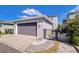 Attached two-car garage in grey with walkway to fenced backyard at 11309 Grand Park Ave, Riverview, FL 33578