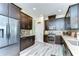 Modern kitchen features stainless steel appliances, gray backsplash, quartz countertop, and hardwood-style flooring at 11309 Grand Park Ave, Riverview, FL 33578