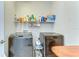 Well-organized laundry room with modern washer and dryer units, and storage at 11309 Grand Park Ave, Riverview, FL 33578