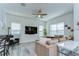 Bright living room features a comfortable sofa, large TV, and large bright windows at 11309 Grand Park Ave, Riverview, FL 33578